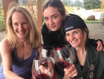 a group of people holding wine glasses and smiling at the camera