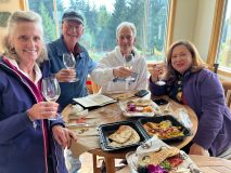 a group of people sitting at a table with food